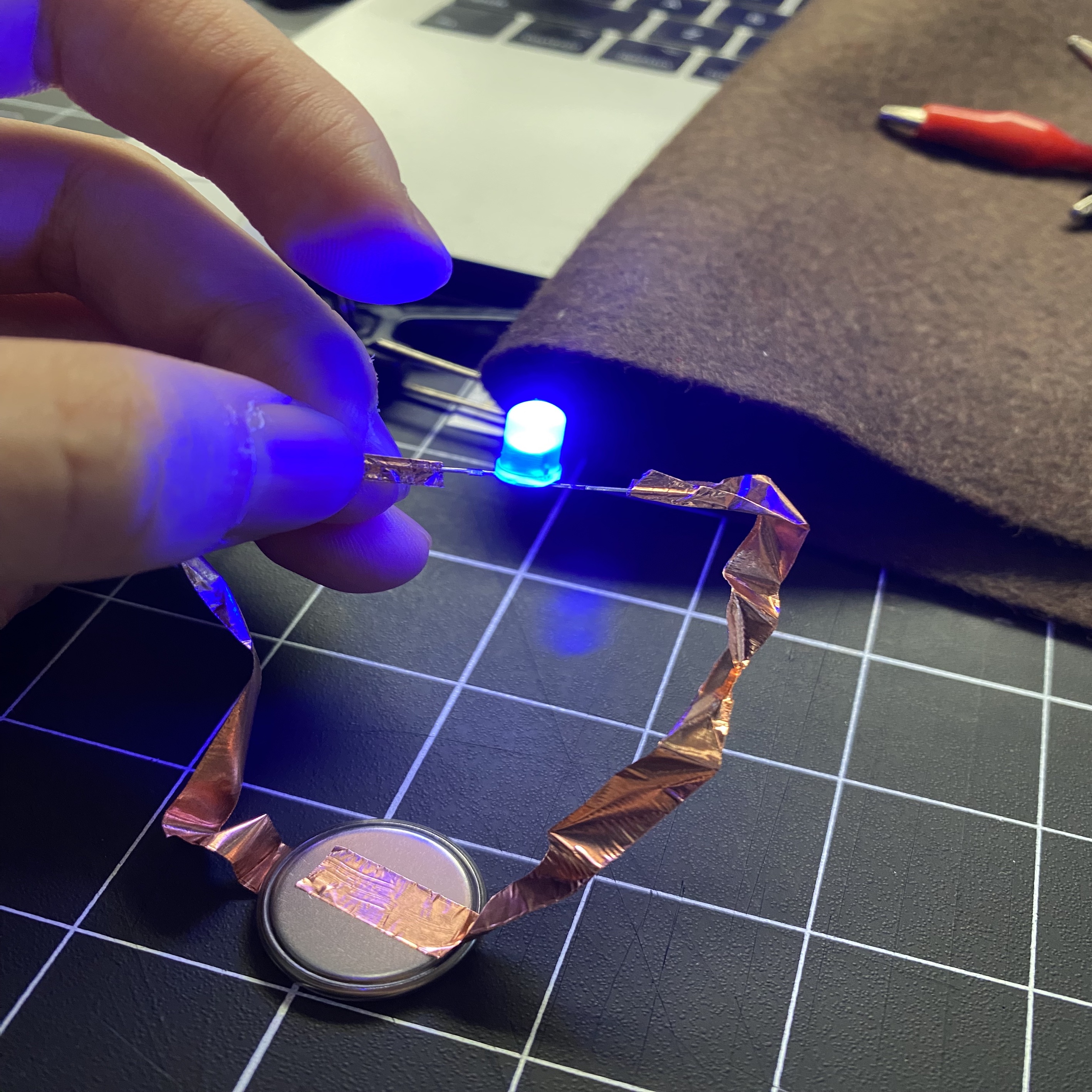 A hand-woven string of LED lights made with conductive tape