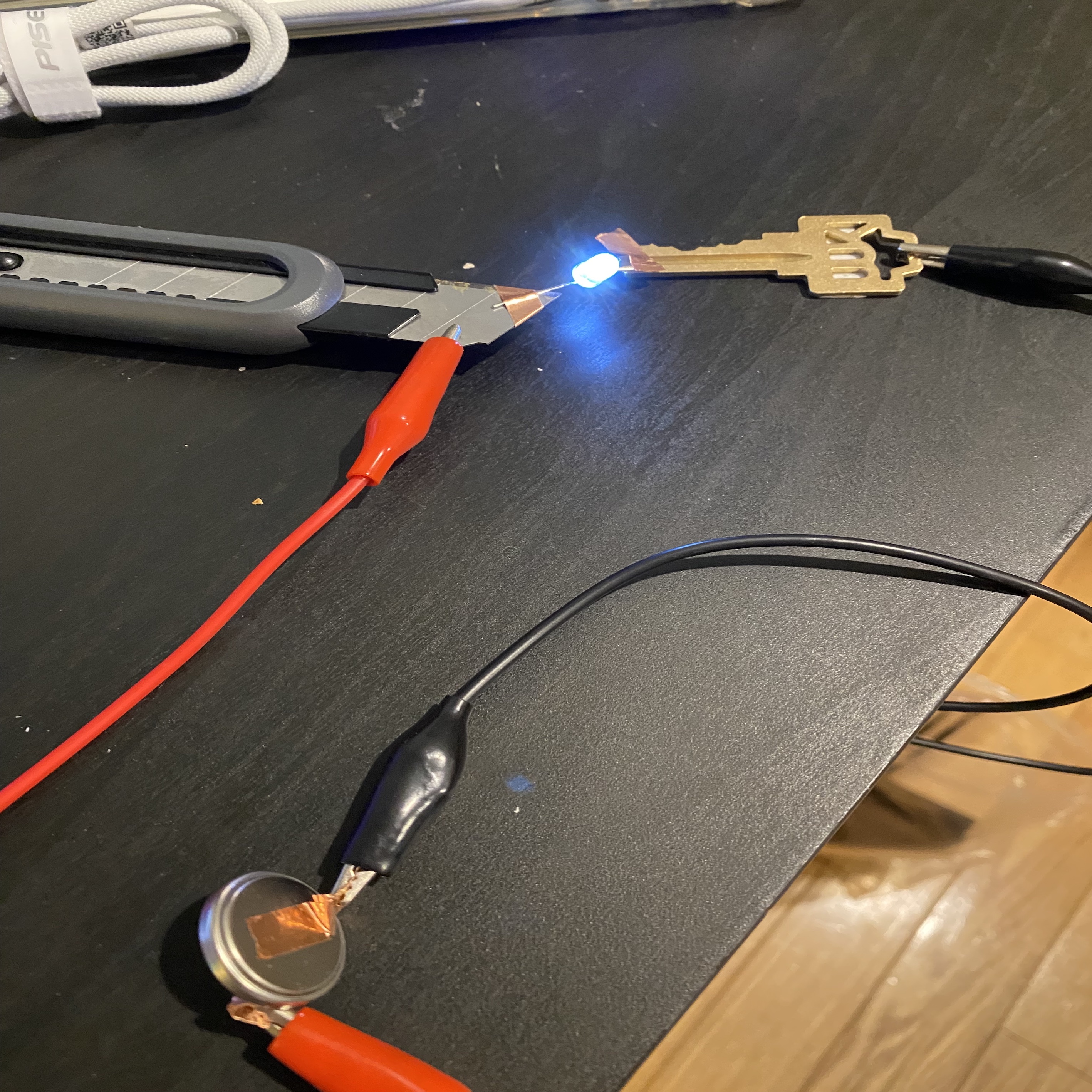 Try to use a utility knife and a key as conductors to create a circuit.